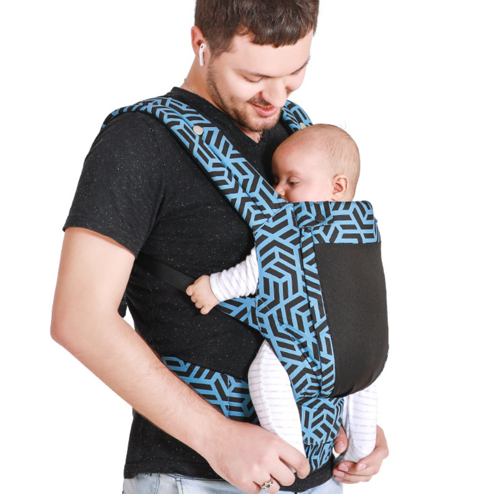 photo of a man carrying a baby in the ergonomic baby carrier